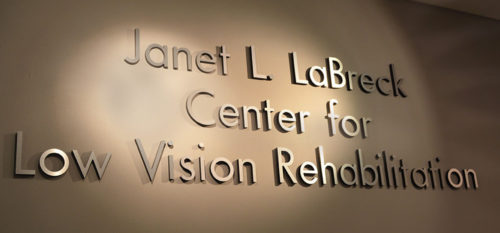 Raised lettered sign on wall with words Janet L. LaBreck Center for Low Vision Rehabilitation.